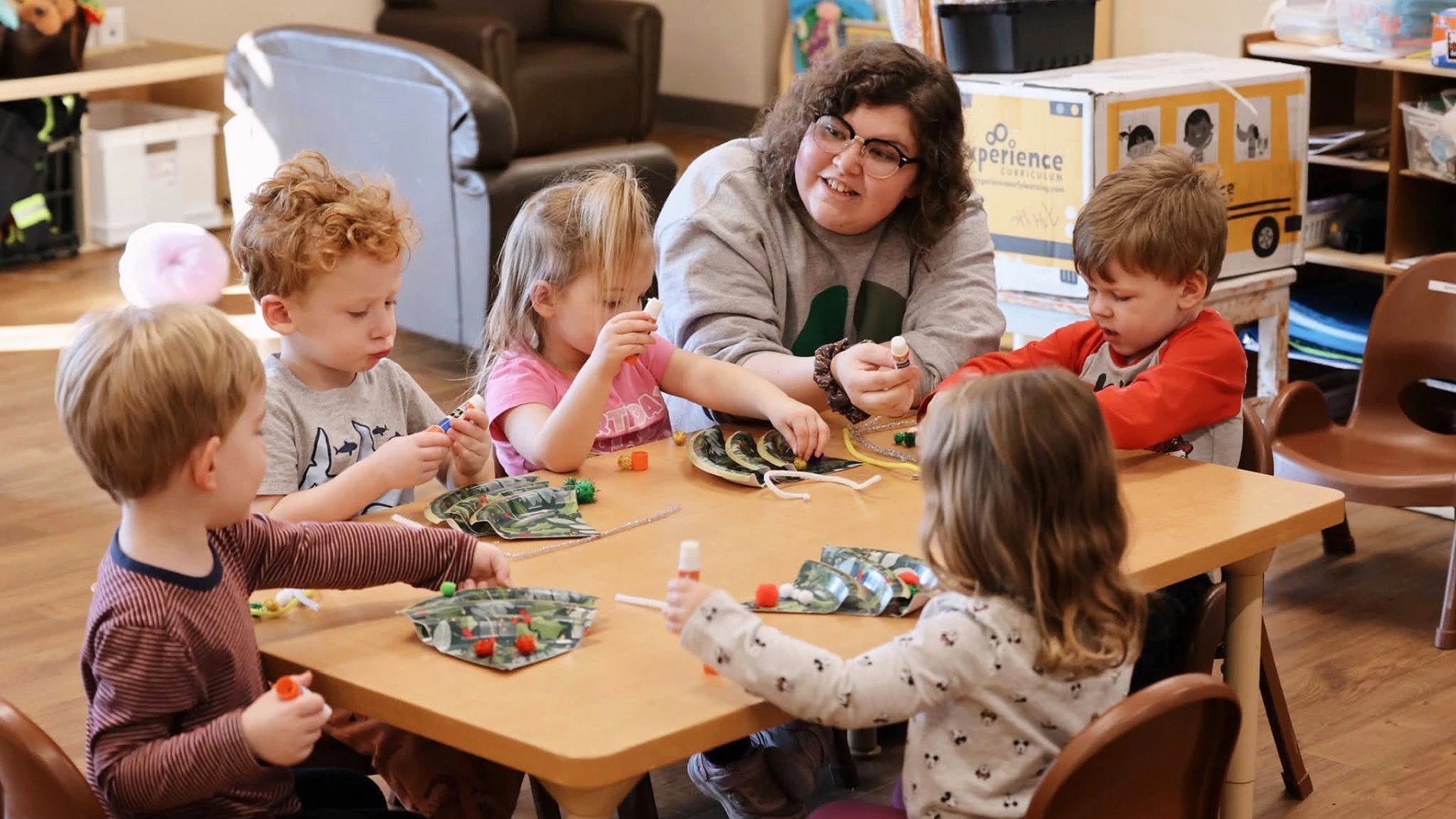 Teacher sitting with children