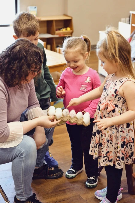 adult holding egg carteen for children