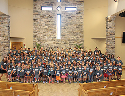 students and teachers at church